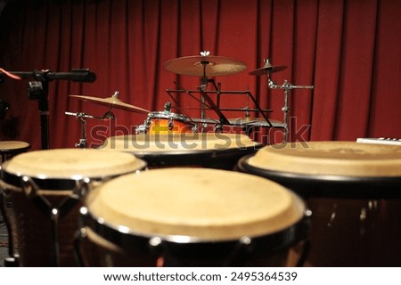 bongo drums with drum kit in the background