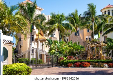 Bonita Springs, Florida Town In Collier County With Entrance To Famous Barefoot Beach With Street Road Through Neighborhood Luxury Houses