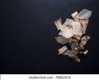 Bonito flakes made from dried, smoked and thinly shaved skipjack tuna flakes. Isolated on black background