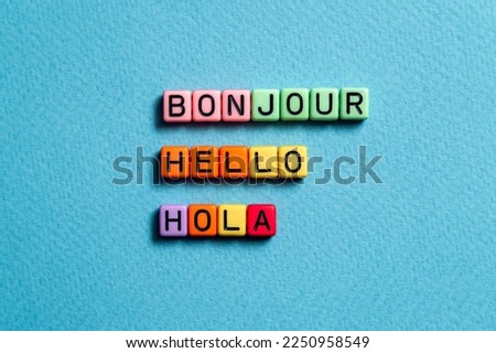Bonjour hello hola - word concept on cubes, text, letters