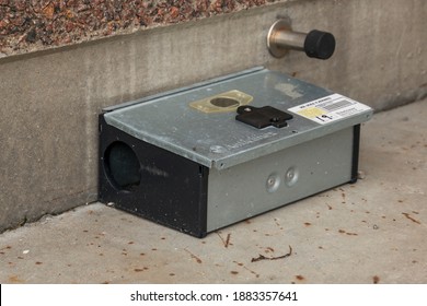 Bonnerup, Denmark - 15 Juli 2020: Grey Metal External Rodent Rat Bait Station Outside Against A Brick Wall Close Up. Pest Control.