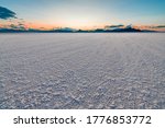 Bonneville Salt Flats colorful landscape twilight sunset near Salt Lake City, Utah and silhouette view of mountains and sun setting behind clouds