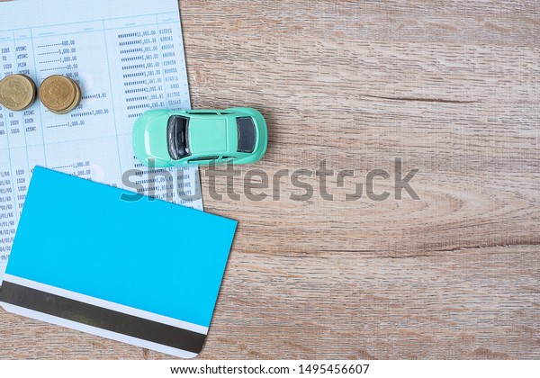 Book bank with Car on wood table background with\
copy space. financial, money, refinance, Car for cash and Car\
insurance concept