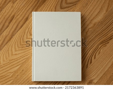 book blank cover, isolated mockup book with realistic shadow on a clean background. Front view of elegant notepad or photobook with binding mock up for catalog.