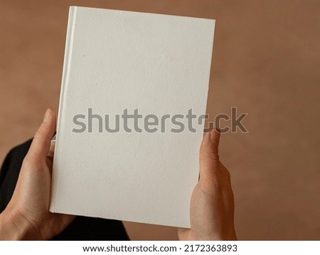 book blank cover, isolated mockup book with realistic shadow on a clean background. Front view of elegant notepad or photobook with binding mock up for catalog.