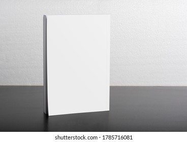 Book With Blank Cover On Dark Glossy Table, Editable Mock-up Series Ready For Your Design, Selection Path Included. 