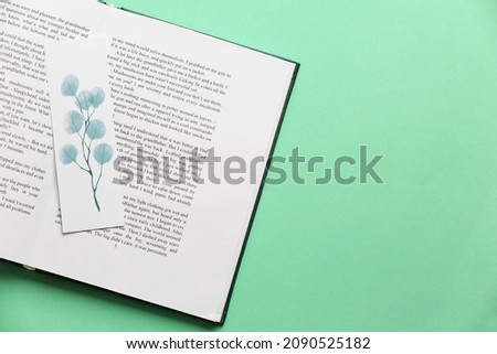 Book with bookmark on color background