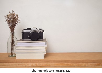 book and camera on shelf in room - Powered by Shutterstock