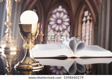 The book of Catholic Church liturgy and rosary and cross. Catholic theme.
