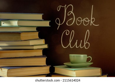 Book Club, Toned Image. A Stack Of Books With A Cup Of Coffee And Chalk Lettering On A Blackboard