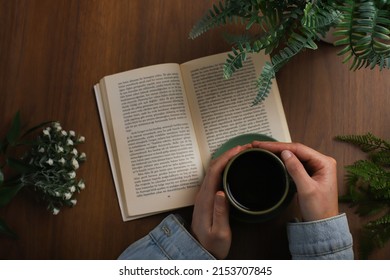 Book And Coffee On Wooden Background. Novel And Coffee Pleasure In Greenery. The Perfect Combination Of Book And Coffee