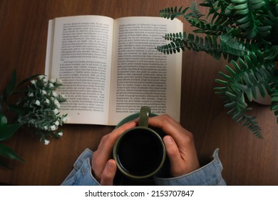 Book And Coffee On Wooden Background. Novel And Coffee Pleasure In Greenery. The Perfect Combination Of Book And Coffee