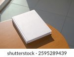 book cover mockup design. blank book mockup on round wooden coffee table on balcony or outdoor terrace , shadow overlay