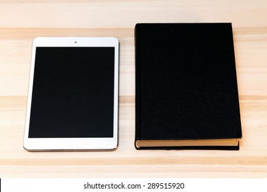 book and digital tablet on the table