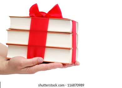 Book as a gift. A stack of books in female hands on a white background.