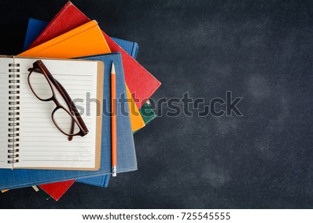 Book glasses and pencil on the desk with study and education concept
