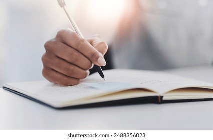 Book, hand and writing with business person closeup at desk in office for notes or planning. Agenda, appointment and schedule in diary, journal or planner at corporate workplace for profession - Powered by Shutterstock