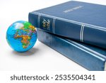 Book of Holy Bible with globe. It is laying on white background. Symbol of faith and worship in God. Religious christian service, missionary, holiday or concept