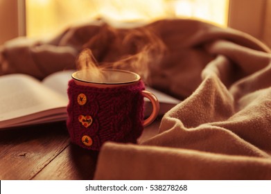 Book Hot Tea And A Warm Blanket At Sunset. The Concept Of Comfort. Read Bestseller. Warm Home.