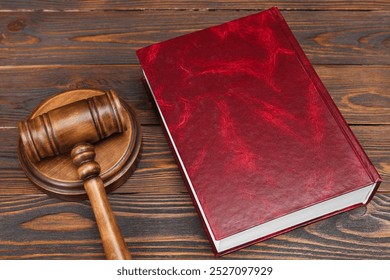 Book and judge's gavel on wooden table - Powered by Shutterstock