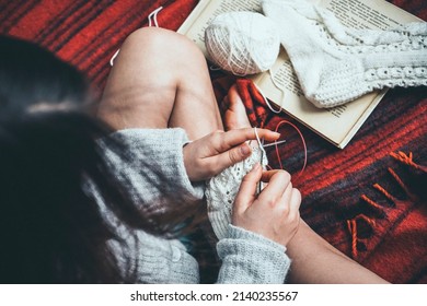 Book And Knitted Sock Near Knitting Girl 