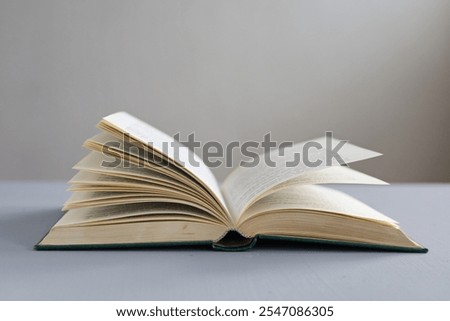  book of knowledge open on gray table ready to read. Open book on gray background, illustration, knowledge, reading, science, history, studying