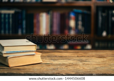 The book in the library (school, university, college) on the table. Reading, literature, learning and back to school concept. Copy space.