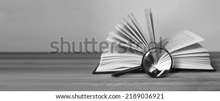 Book and magnifying glass banner with background for text. High quality photo