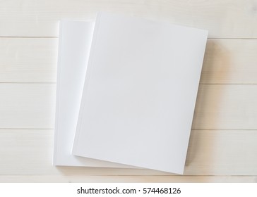 Book mock up cover blank A4 size paperback mockup for catalog, magazine booklet, portfolio, menu design template with page front side on white surface on wood table