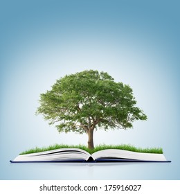 book of nature with grass and tree growth on it over white blue background