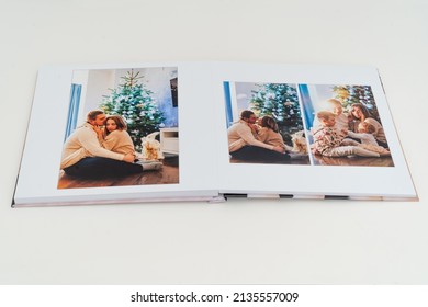 A Book With New Year Photos Of Big Family At Home On A White Background. Photobook Is Gift. Professional Photographer And Designer. Printing Of Photos And Journals In Photo Laboratory