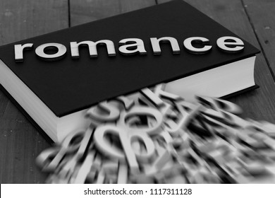 Book Novel With The Word Romance And Blurred Letters Coming Out Of The Pages On A Wood Background