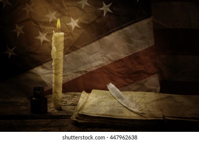 Book And Old US Flag. Book And Feather Near Candle. Stories From Bygone Epoch. History Teaches The Nation.