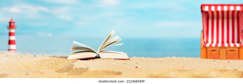 Book on the sandy beach with a beach chair and lighthouse - Powered by Shutterstock