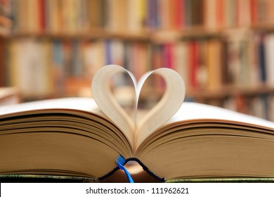 Book page in heart shape with library background