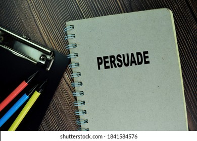 The Book Of Persuade Isolated On Wooden Table