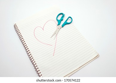 Book With Scissors And A Heart Drawn On A Dull  Background