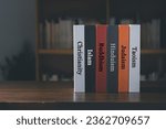 Book spines listing major world religions - Christianity, Islam, Hinduism, Buddhism, Taoism and Judaism. religion concept.