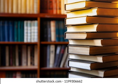 Book stack  blurred bookshelf in the library room, education background, back to school concept
