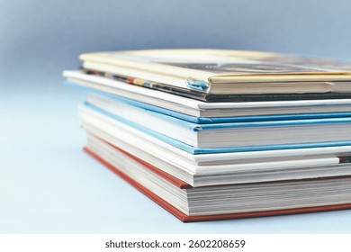 Book stack close up on blue background
