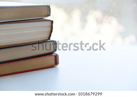 Book stack in the library room and blurred bookshelf, business and education background