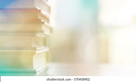 Book stack wood desk   blurred bookshelf in the library room  education background  back to school concept