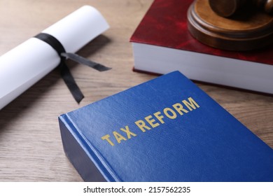 Book With Text TAX REFORM On Wooden Table, Closeup View