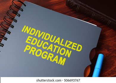 Book With Title Individualized Education Program (IEP) On A Table.