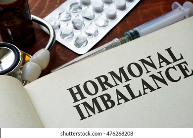 Book With Words Hormonal Imbalance On A Table.