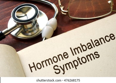 Book With Words Hormone Imbalance Symptoms On A Table.