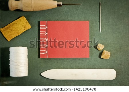 Bookbinding Tools with Hand Sewn Book Viewed from above