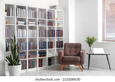 Bookcase with armchair in modern interior of room - Shutterstock ID 2110284530