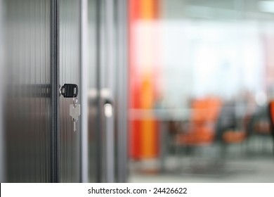 Bookcase And Keys In Modern Office (soft Focus)