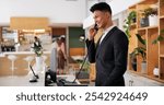 Booking, hotel reception and call of concierge with man, customer care and hospitality enquiry. Staff, service work and travel question at lobby desk with conversation, helping and guest support